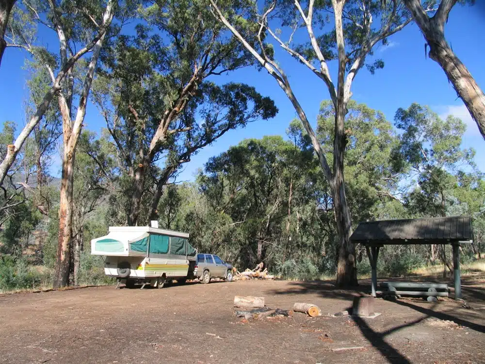 Caravan parked outdoors with a raised pop-top roof