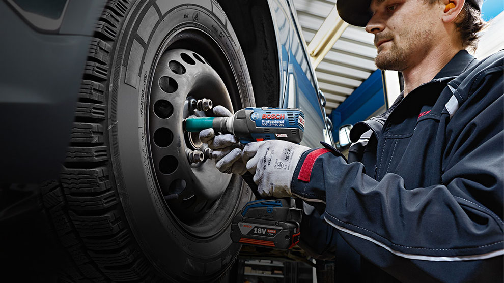 Technician repairing a car wheel using Bosch parts