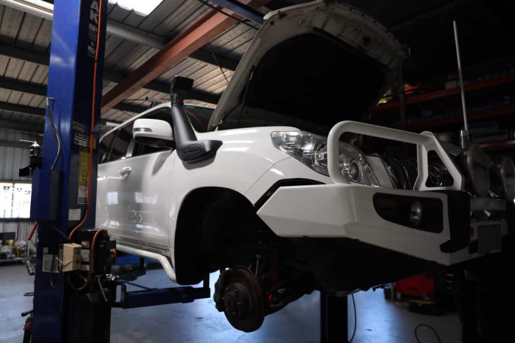 Car undergoing repairs in a workshop