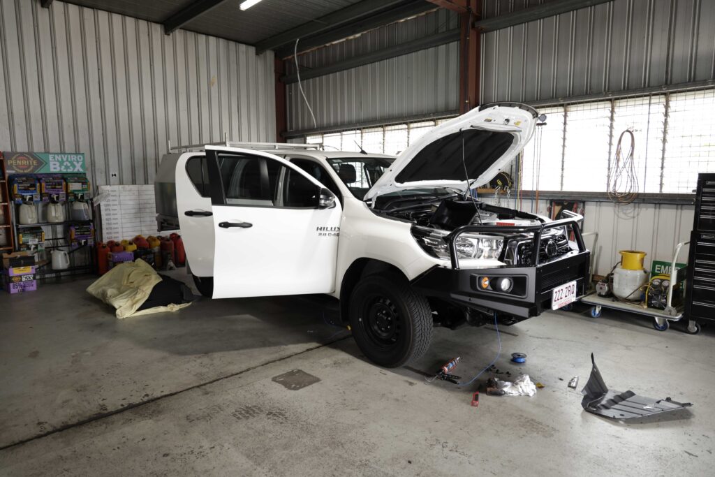 Vehicle receiving service inside a well-equipped garage.