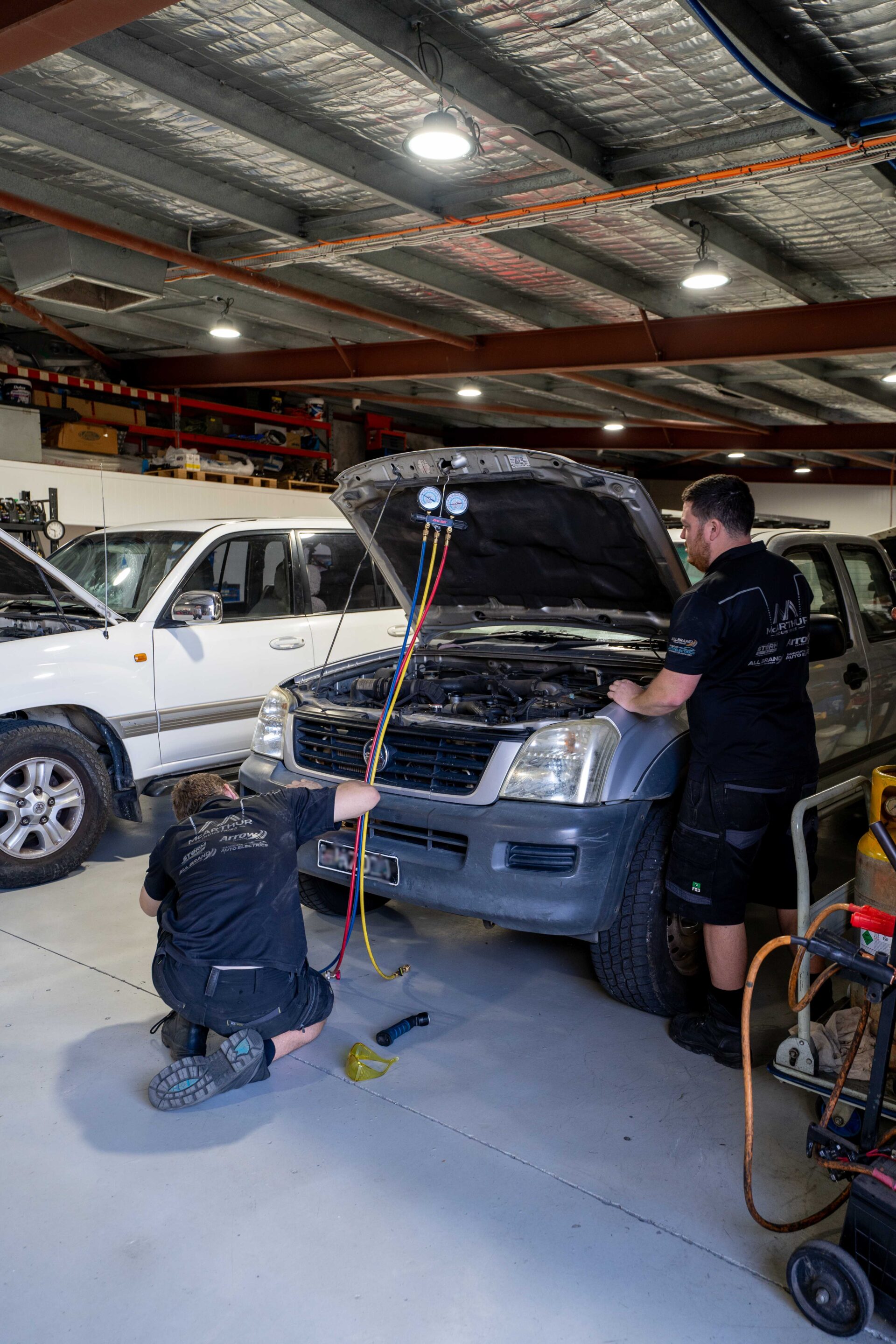 Car mechanic inspecting the engine of a vehicle in a workshop