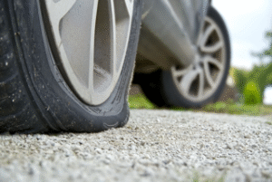 car owner with flat tyre